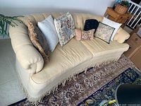 Front view of curved chenille sofa with pillows on seat