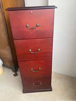 Front view of mahogany 4-drawer file cabinet, closed drawers