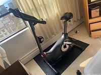 Full side view of Schwinn upright exercise bike on mat