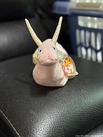 Front view of Ty Beanie Baby Swirly snail plush with tag