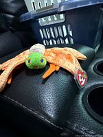 Full view of Ty dragonfly plush on seat