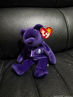 Front view showing full bear with tag and chest rose