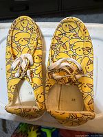 Top view of both shoes showing duck pattern and laces