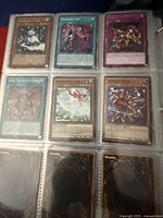 First binder page showing six Yu-Gi-Oh cards in sleeves