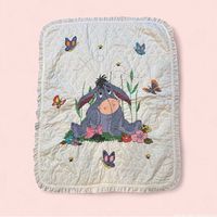 Front view showing full Eeyore stitched design, butterflies, flowers, ruffled edge