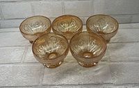 All five marigold Jeanette Iris & Herringbone footed sherbet bowls displayed together