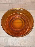 Top view of marigold carnival glass bowl showing radial rib pattern