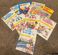 All nine unused Preschool Practice workbooks arranged on carpet
