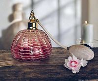 Front view of pink lattice art glass perfume bottle with attached bulb atomizer