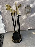 Full view of stand and four golf club-headed tools