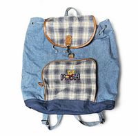 Front view showing plaid flap, front zip pocket with Pooh embroidery, denim body