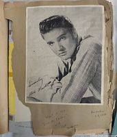 Elvis Presley promotional photo mounted in scrapbook with handwritten note and date