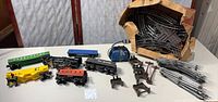 Entire lot on table: loco, tender, cars, transformer, tracks, box