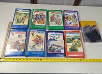 All nine boxed Intellivision games laid out with ruler for scale