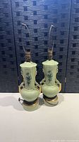 Both mint green ceramic lamps side by side