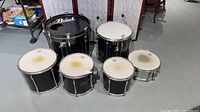 Front view of all six black Pearl drum shells with heads attached