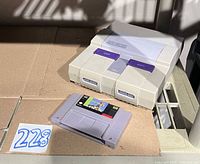 Console and game cartridge on shelf