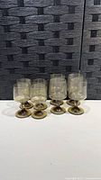 Eight smoked stemmed glasses grouped together