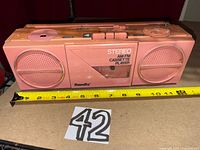 Front view showing pink Randix stereo cassette player with twin speakers and cassette deck