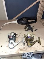 Pocket Fisherman, South Bend R2F, Zebco RTSP on shelf