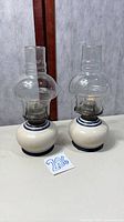 Both porcelain oil lamps front view