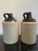Two stoneware jugs side by side showing form and glaze