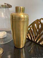 Brass cocktail shaker, napkin holder edge, part of lantern