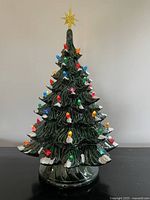Full view of illuminated ceramic Christmas tree with star