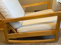 Side view showing wood frame and seat cushion