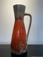 Full view of jug showing overall form, handle, and glaze pattern