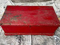 Top view of red wooden trunk showing distressed paint and overall shape