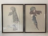 Both framed Gruerio prints side by side