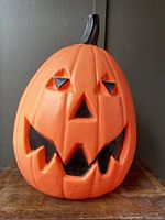 Front view of large blow mold pumpkin showing face and stem