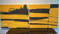 Front view showing both abstract paintings with black and yellow palette