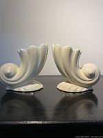 Pair of matching ivory cornucopia vases side view