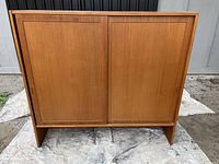 Front view showing entire teak cabinet top with sliding doors