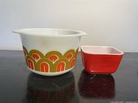 Casserole and one small red dish side by side showing size and pattern