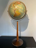 Full view of Replogle globe on teak pedestal and metal base