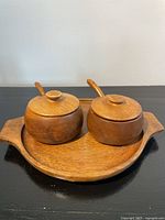 full view of two lidded bowls on tray