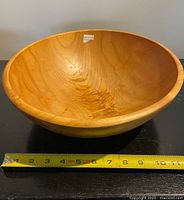 Overall view of wooden bowl with tape measure showing diameter
