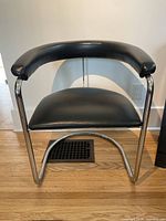 Front view of black vinyl and chrome side chair