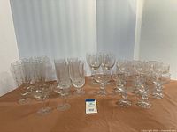 Entire assortment of clear stemware and drinkware arranged on surface