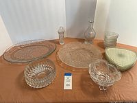 Full lot showing all pressed-glass items on table