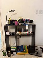 Front view showing shelf, lamp, supplies, calculators and organizers