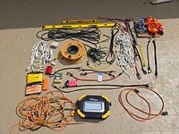 Overall view of lot spread out showing cords, levels, reels, work light and accessories