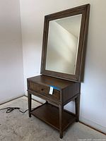 Console table with drawer and lower shelf, mirror resting on top