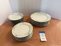 Three stacks of matching Dynasty Fine China dinner plates, salad plates and rimmed bowls