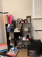 Front view showing cube shelf filled with office supplies and additional organizers on floor