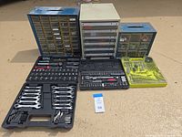 Group shot of three drawer organizers, two black tool cases and yellow bit set