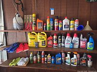 Wide view of shelves showing full assortment of automotive fluids, aerosols, towels and funnel